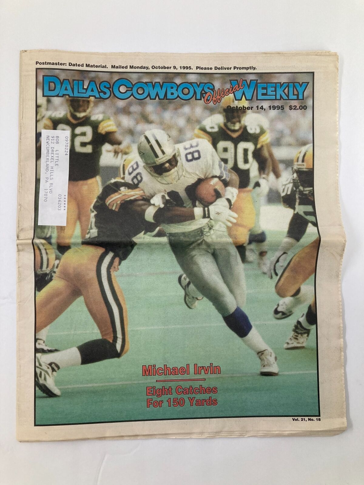 Dallas Cowboys Weekly Newspaper October 14 1995 Vol 21 #18 featuring Michael Irvin on the cover, showcasing him in action against an opposing player.