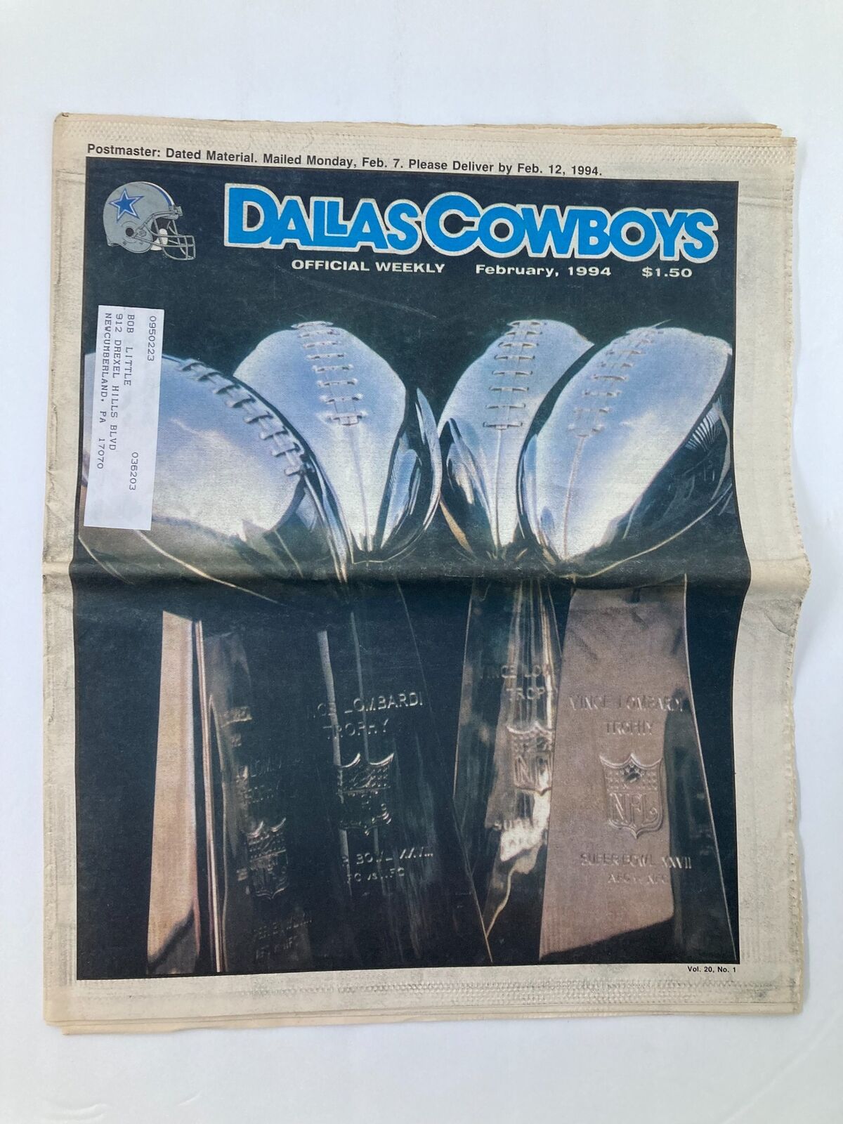 Dallas Cowboys Weekly Newspaper February 1994 Vol 20 #1 featuring quarterback Troy Aikman on the cover, showcasing three football trophies and a football logo.