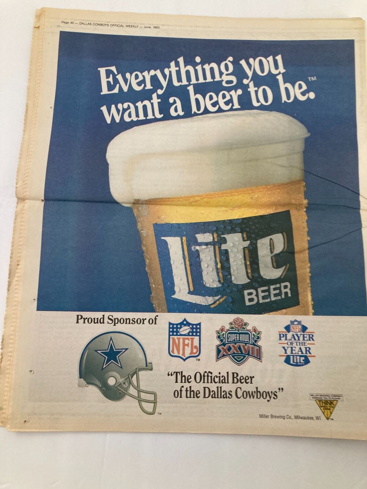Advertisement in the Dallas Cowboys Weekly Newspaper June 1993 Vol 19 #5 The Ring World Championship featuring a beer brand and Cowboys logos, symbolizing sponsorship and team spirit.
