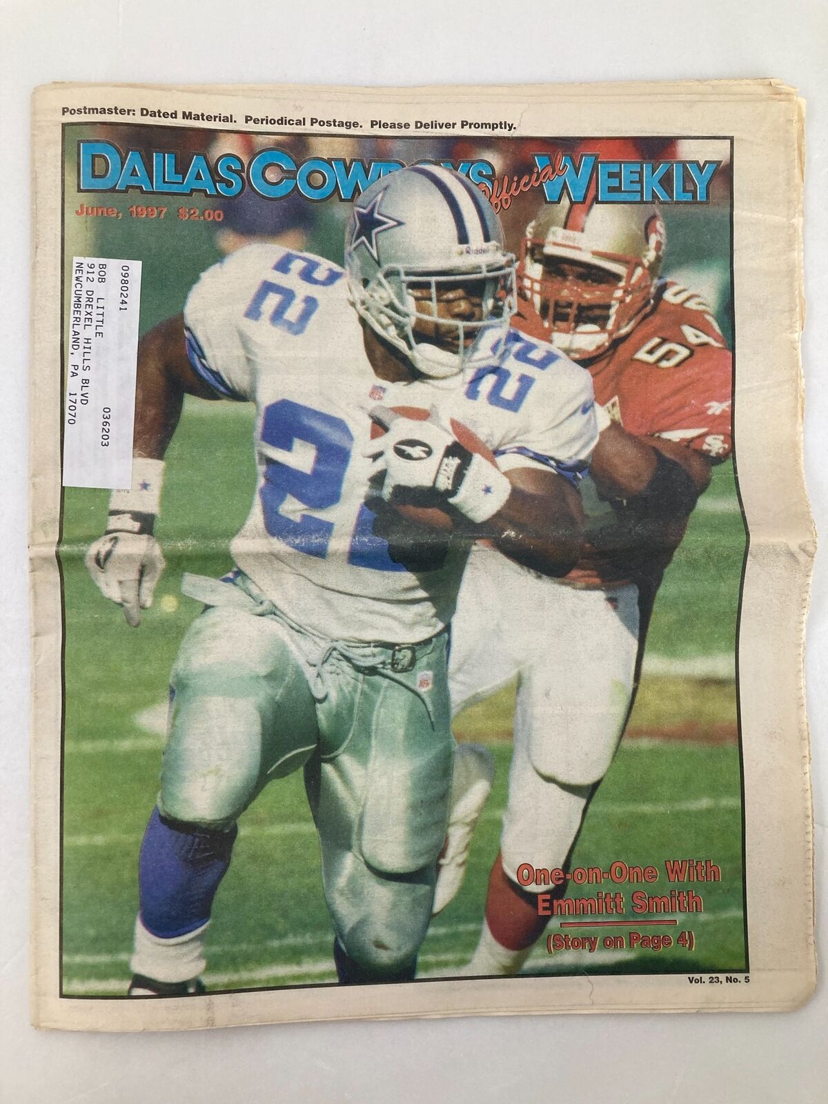 Dallas Cowboys Weekly Newspaper from June 1997, Vol 23 #5 featuring Emmitt Smith on the cover, showcasing him in action while being pursued by a defender.