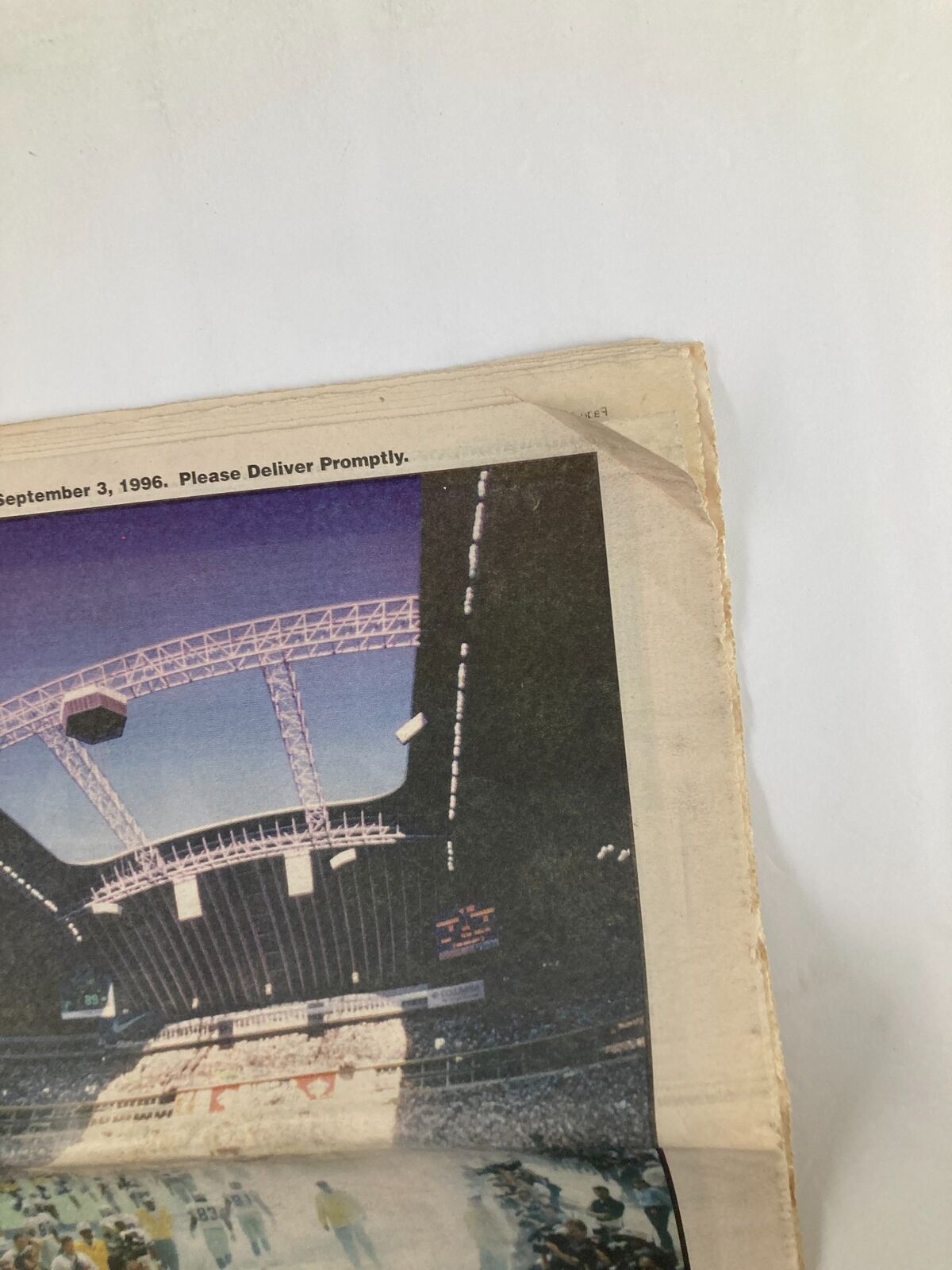 Close-up view of the top corner of the Dallas Cowboys Weekly Newspaper September 7, 1996, Volume 22 #13, showing a crease and the newspaper's date.