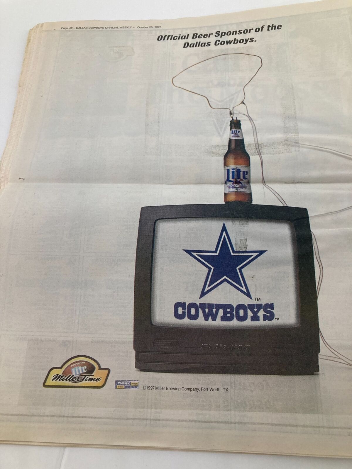 Advertisement in Dallas Cowboys Weekly Newspaper from October 25, 1997, showing the official beer sponsor of the Dallas Cowboys with a Miller beer bottle next to a TV displaying the Cowboys logo.