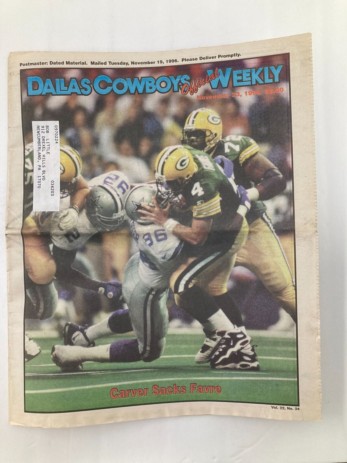Cover of the Dallas Cowboys Weekly Newspaper dated November 23, 1996, featuring Carver Sacks Favre, showcasing an action moment from the Dallas Cowboys vs. Green Bay Packers game.