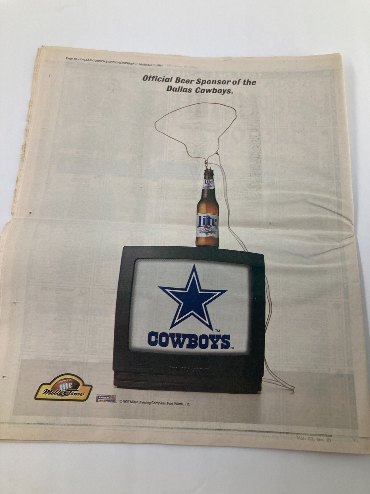 Advertisement page from the Dallas Cowboys Weekly Newspaper November 1 1997 Vol 23 #21 promoting the official beer sponsor of the Dallas Cowboys.