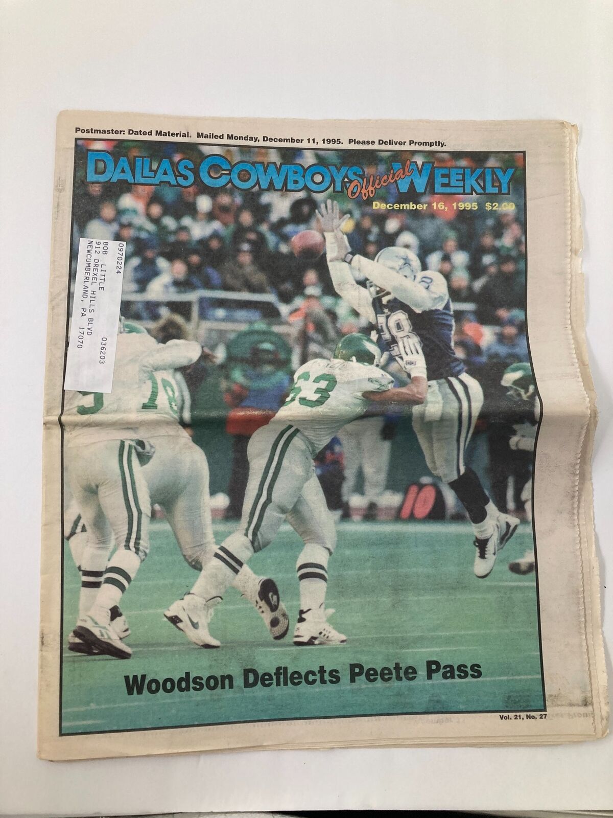 Dallas Cowboys Weekly Newspaper December 16, 1995, Vol 21 #27 featuring Charles Woodson deflecting a pass during a game. Newspaper in good condition with minor wear, includes a label on the front.