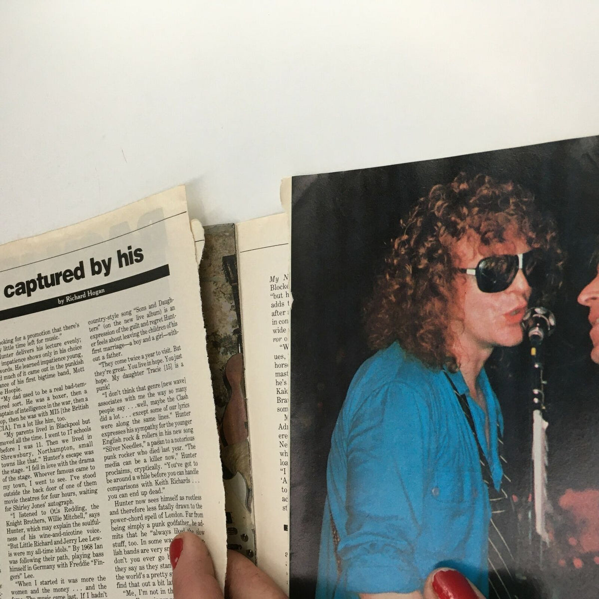 Circus Magazine July 22 1980 Journey Feature & Judas Priest Poster - A close-up view of a page featuring an article titled 'captured by his' along with a photograph of a performer wearing sunglasses and singing into a microphone.