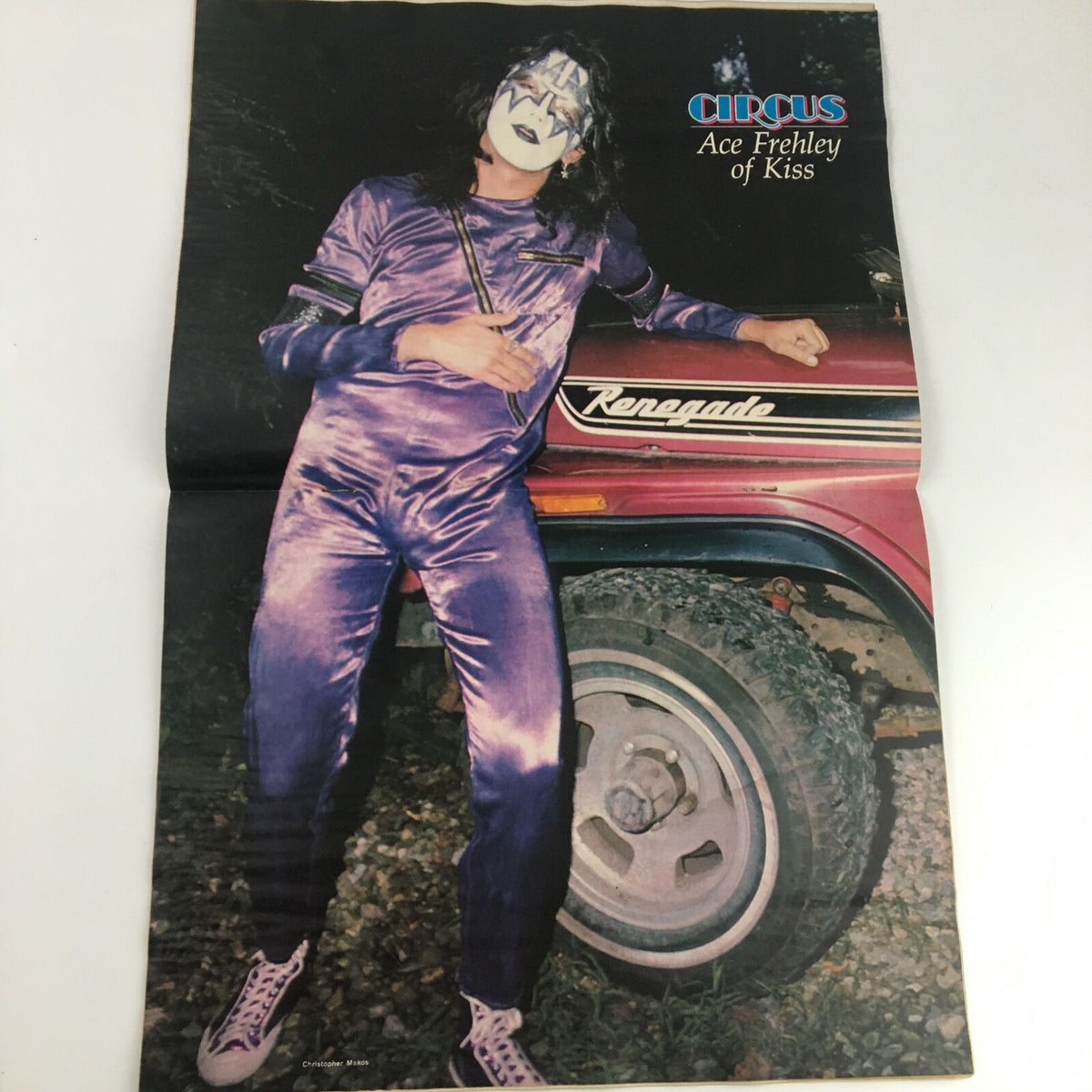 Circus Magazine April 27, 1978 featuring Ace Frehley of Kiss in a purple outfit standing beside a vehicle with the word 'Renegade' visible. This vintage poster is a collectible item for rock and roll fans.