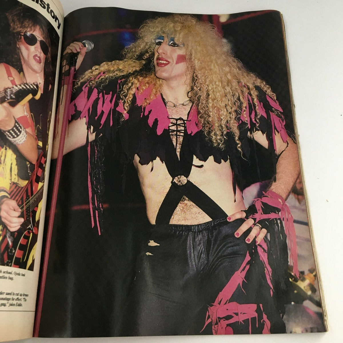 Dynamic photo of a rock singer in costume from Circus Magazine December 31, 1984, representing the flamboyant fashion of 1980s rock culture.