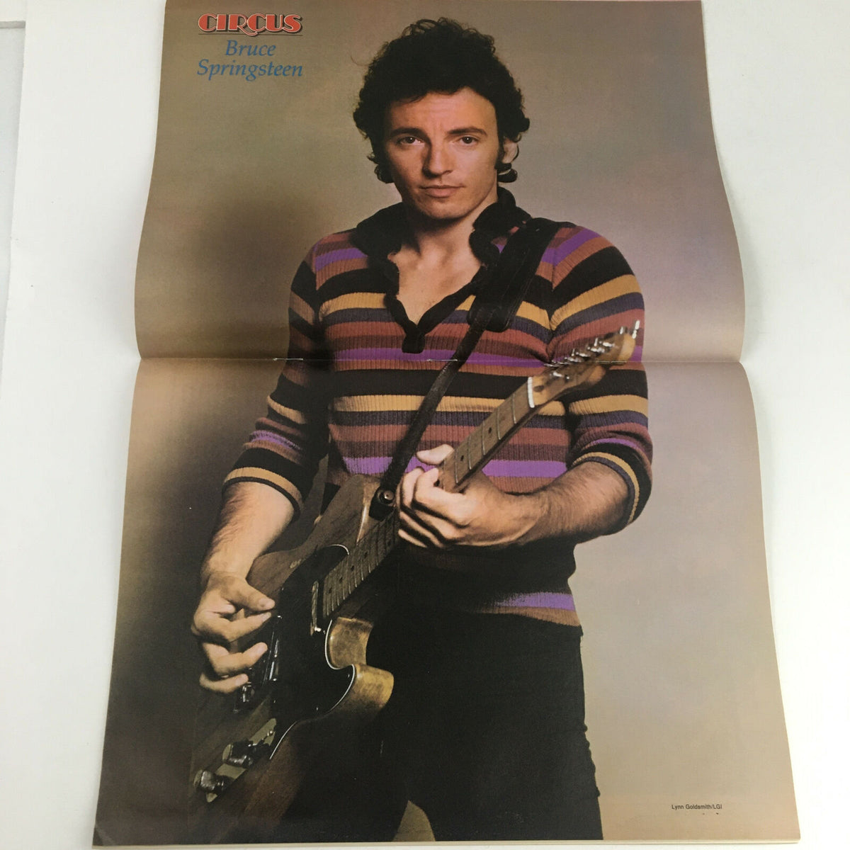 Large poster of Bruce Springsteen featured in Circus Magazine December 31 1980, showcasing the legendary musician holding a guitar.