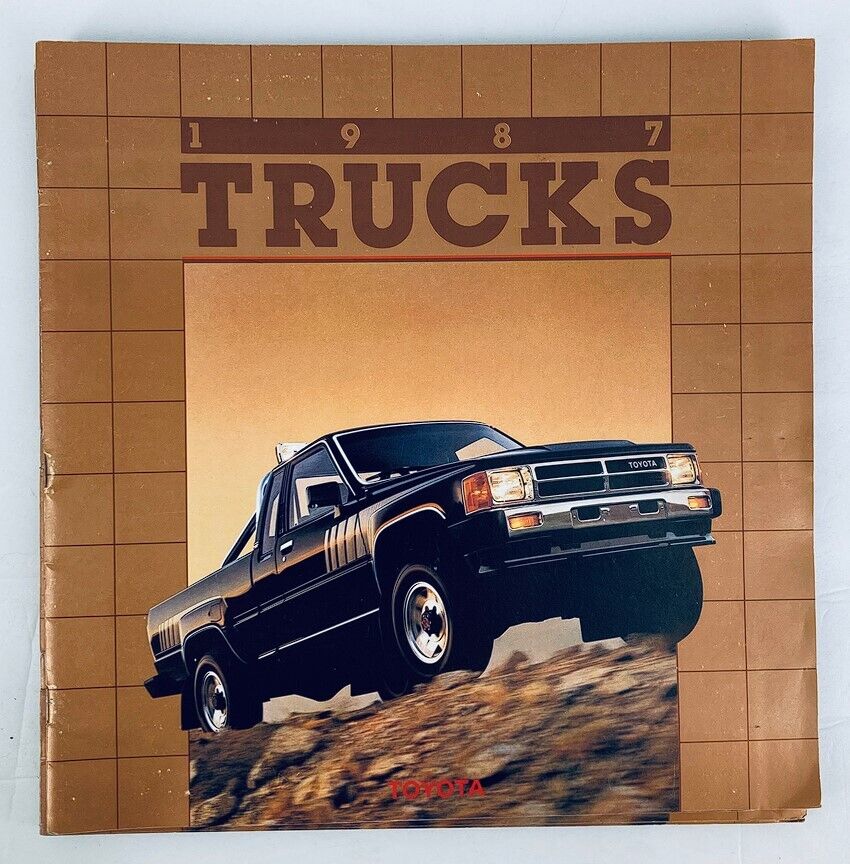 1987 Toyota Trucks Dealer Showroom Sales Brochure Guide Catalog featuring a Toyota truck on rugged terrain, showcasing its off-road capability and design.