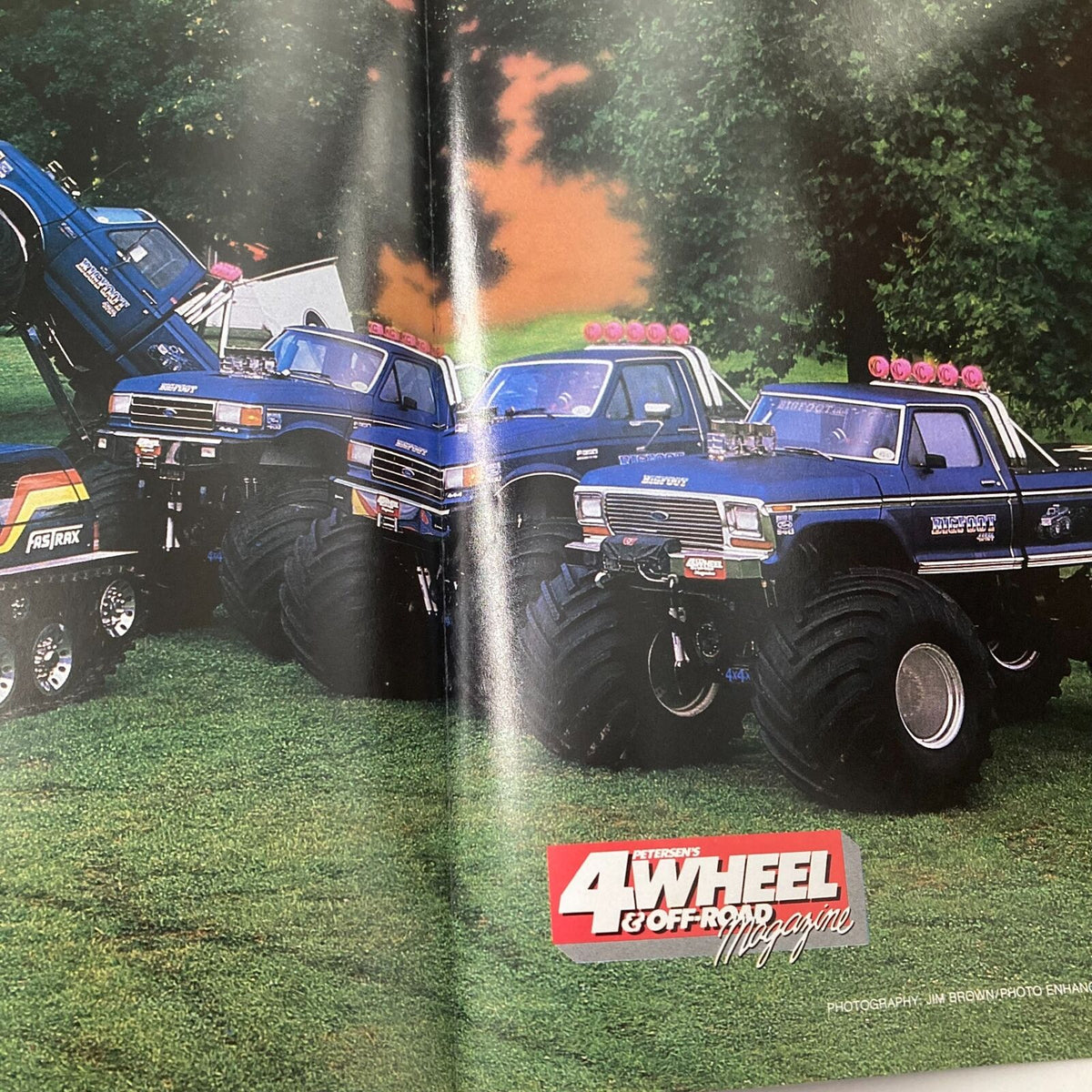 Image of multiple Bigfoot monster trucks in a display setting from Petersen's 4 Wheel & Off-Road Magazine February 1990, emphasizing off-road vehicle innovations.