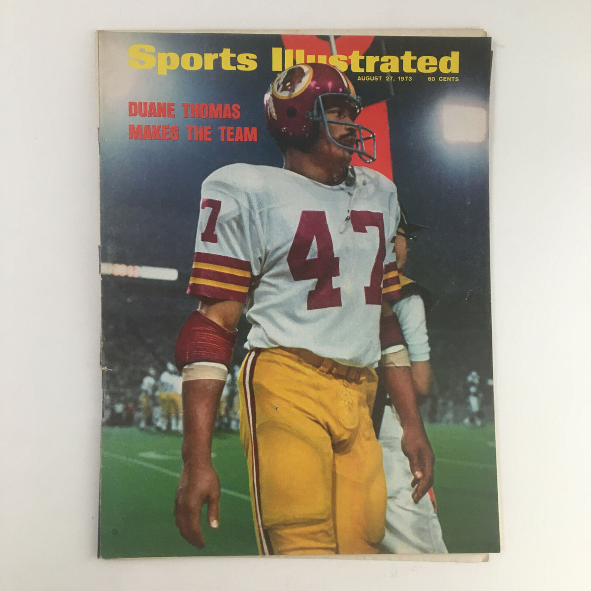 Cover of Sports Illustrated Magazine August 27, 1973 featuring Duane Thomas, showcasing him in team uniform and helmet, celebrating his journey to make the team.
