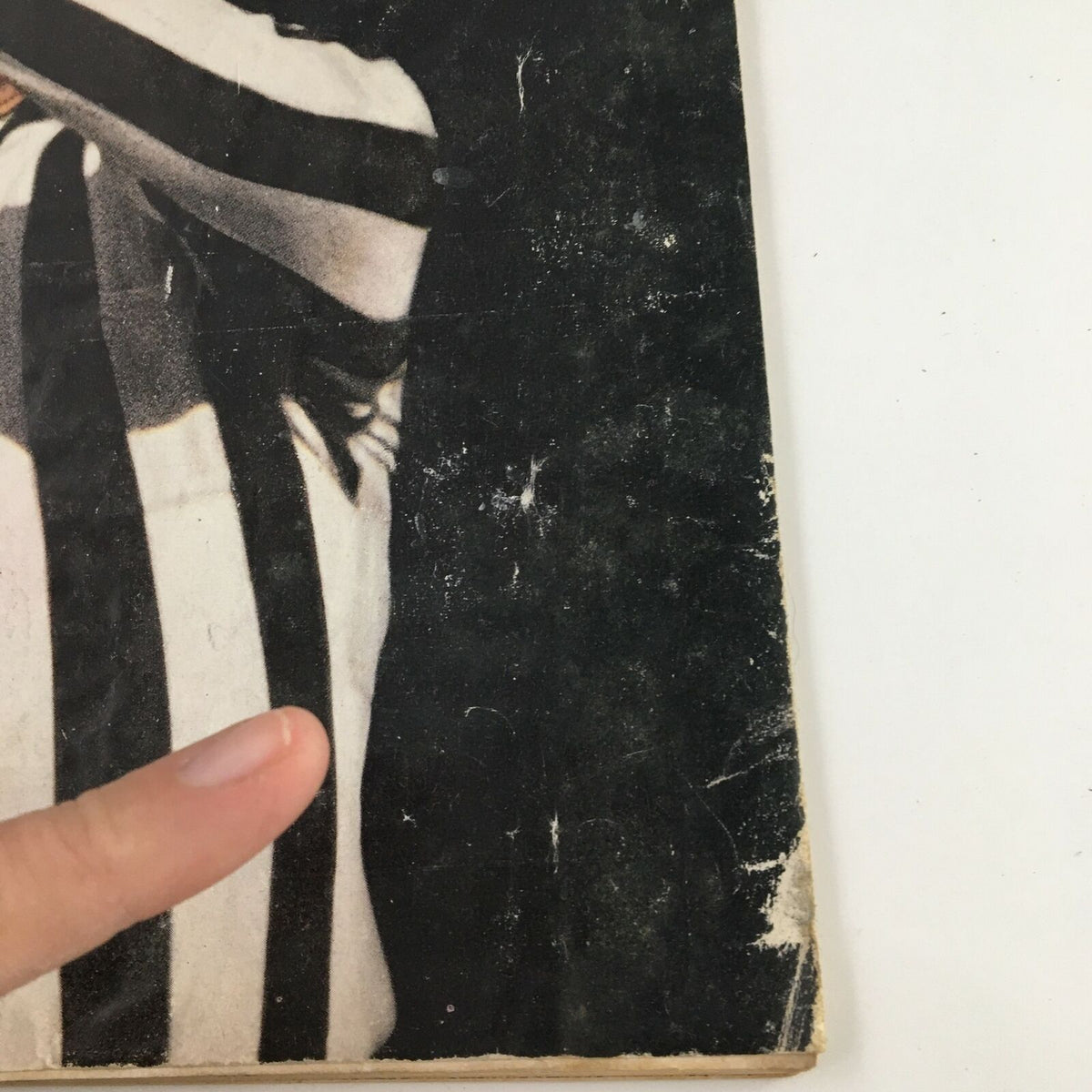 Close-up view of the cover of Sports Illustrated Magazine, November 11, 1963, highlighting details of the referee's hand and uniform, with emphasis on the theme 'War Against Roughness in Pro Football'.