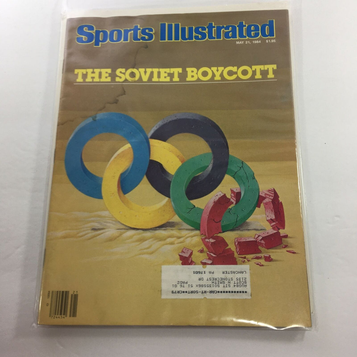 Cover of Sports Illustrated magazine from May 21, 1984, featuring an image related to the Soviet Boycott Olympics, with colorful Olympic rings against a desert backdrop, capturing the historical significance of the event.