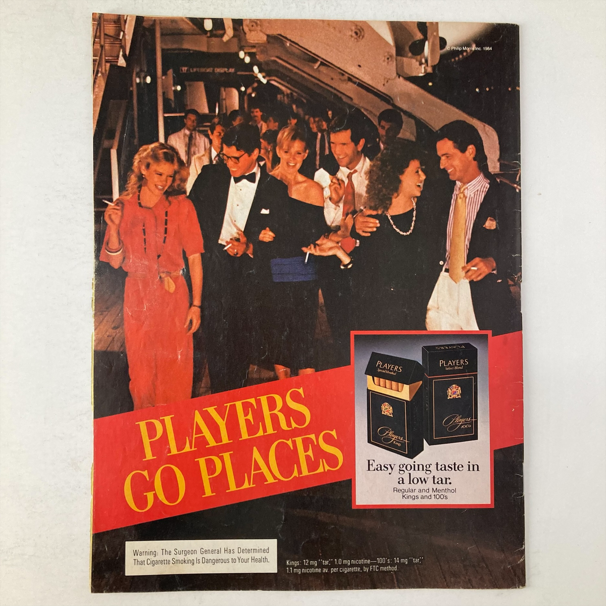 Back cover of VTG US Magazine September 10 1984 featuring a vibrant social scene labeled 'Players Go Places,' showcasing 1980s fashion and lifestyle.