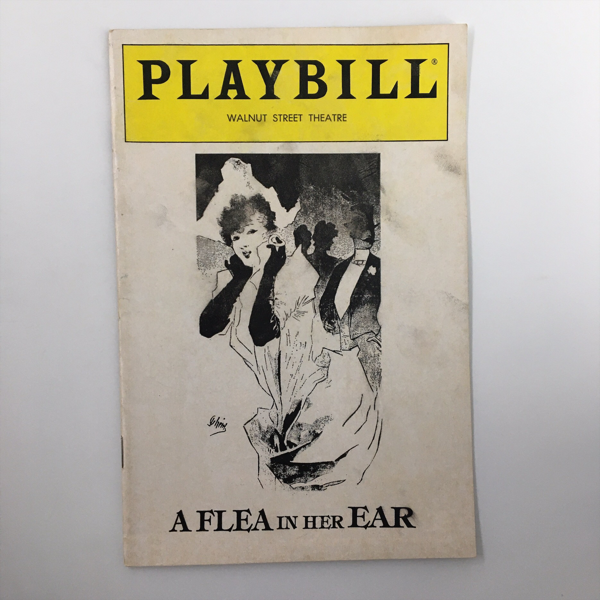 Front cover of the 1982 Playbill for 'A Flea in Her Ear' by Donald Ewer from the Walnut Street Theatre, featuring vintage theatrical artwork and the title prominently displayed.