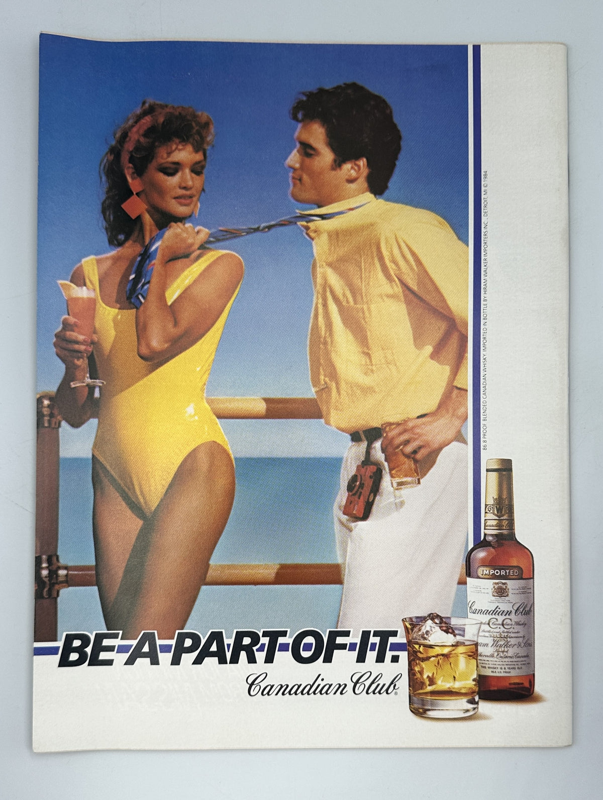 The New Yorker Magazine July 9, 1984 Beach Umbrellas Swimmers Robert Tallon Cover VG, featuring a vintage Canadian Club whiskey advertisement with a woman in a yellow swimsuit and man by a beach railing.