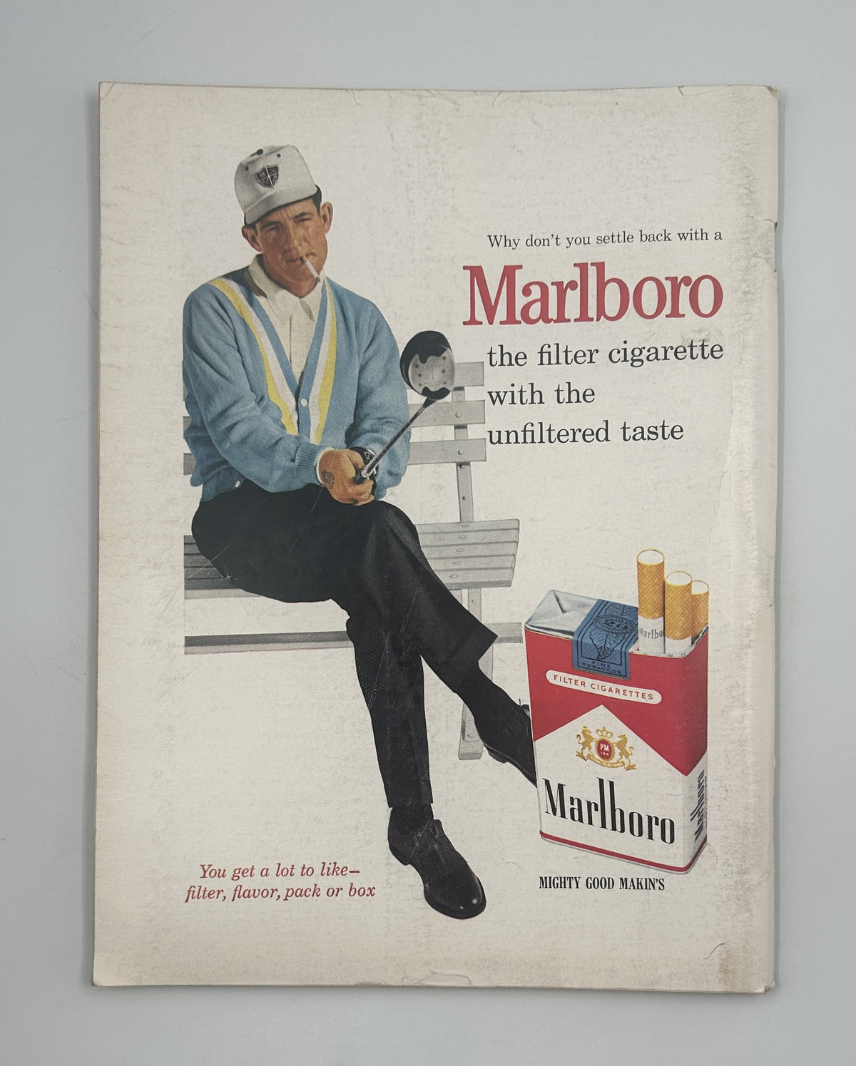 The New Yorker Magazine May 19, 1962 Art Symbols Saul Steinberg Cover, showing a vintage Marlboro cigarette advertisement with a seated golfer and cigarette package.
