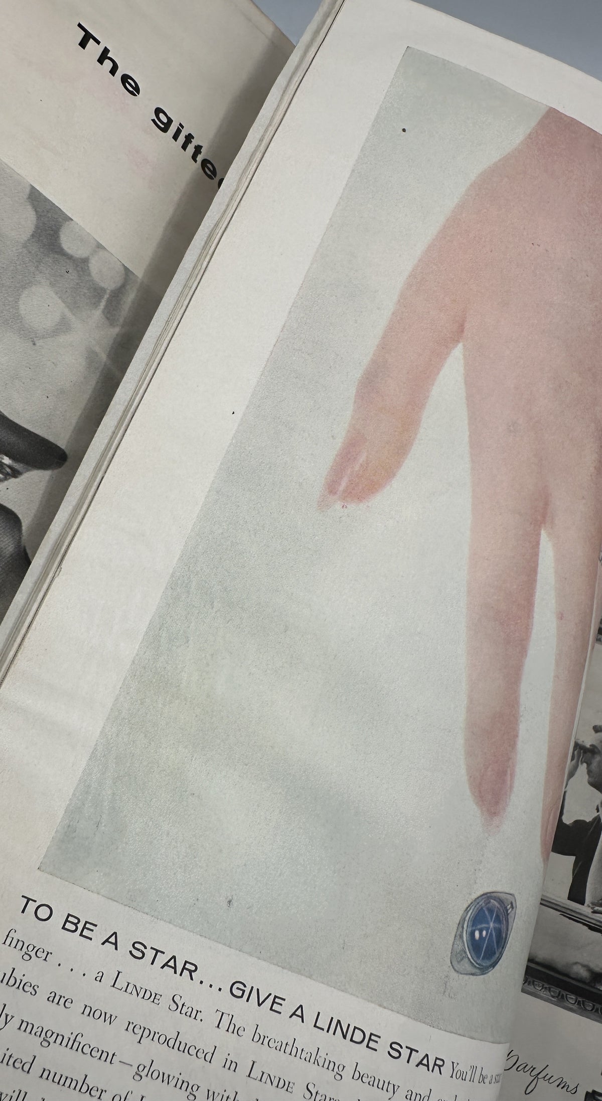The New Yorker Magazine December 10, 1955 Christmas City Lights Daniel Brustlein Cover interior fashion and beauty advertisement showing a close-up of a woman's hand and a blue cosmetic emblem.