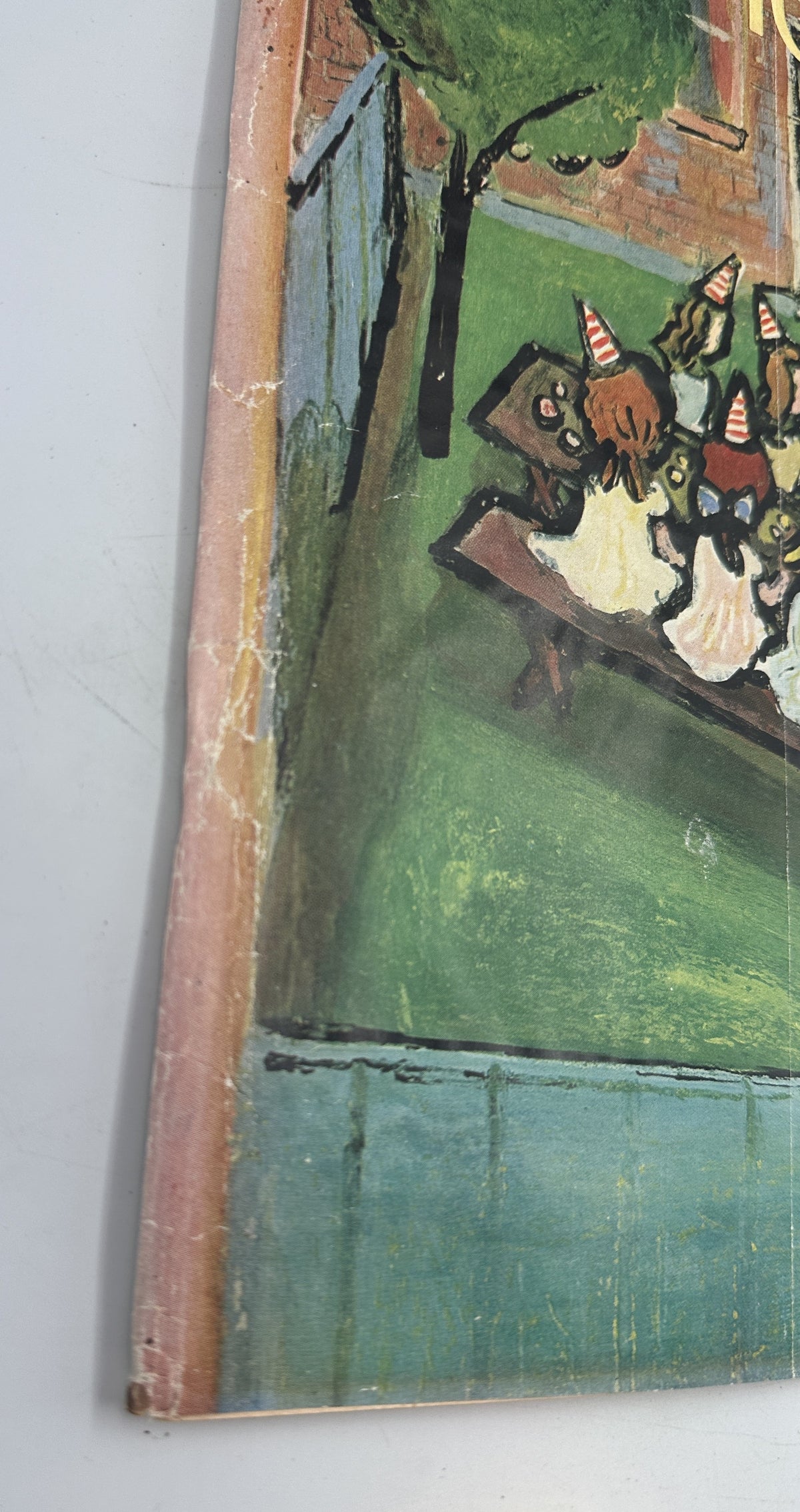Detail of the worn spine and left edge of The New Yorker Magazine August 23, 1958 Birthday Party Abe Birnbaum Cover, showing creasing and age-related wear.