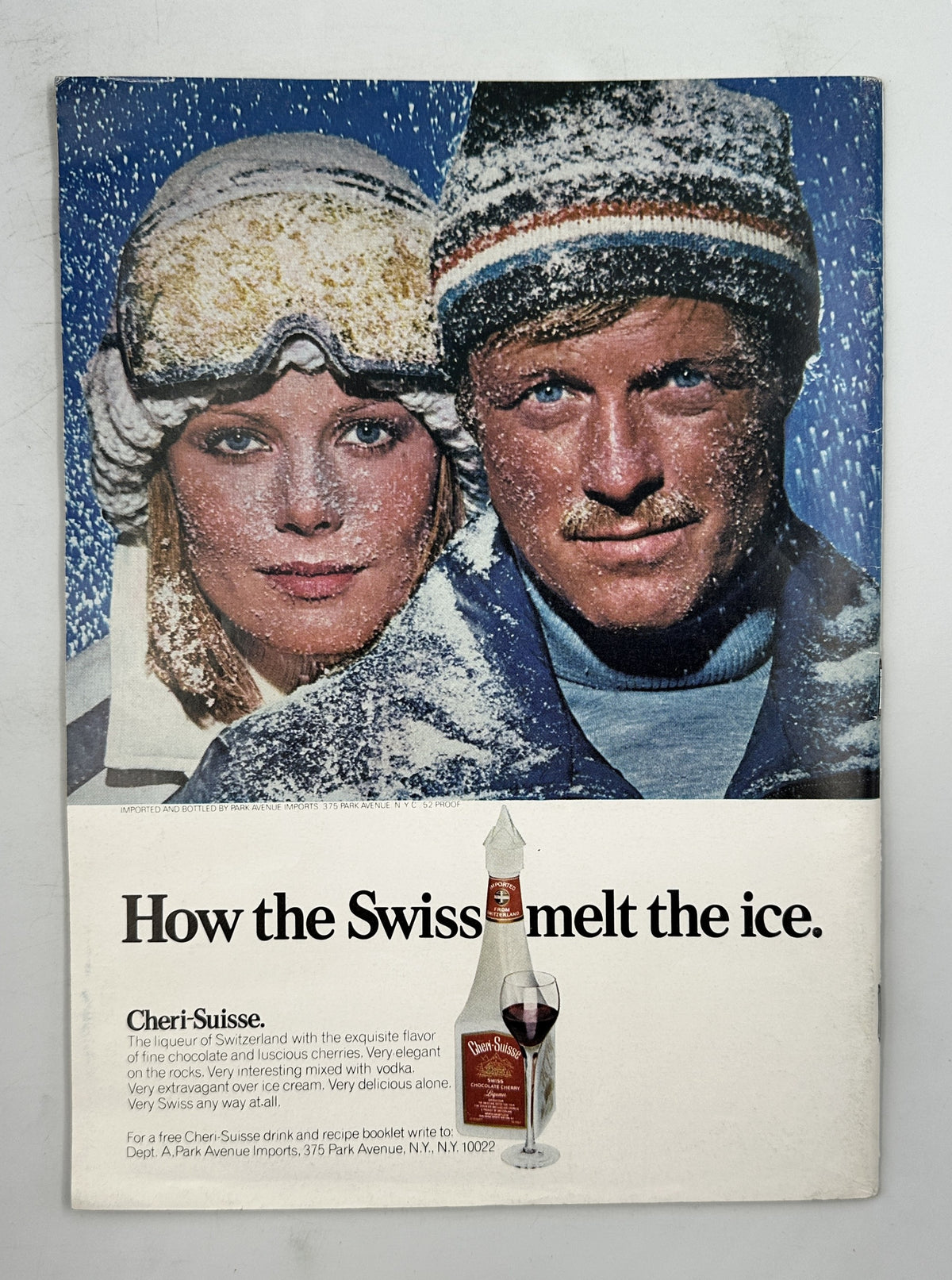 The New Yorker Magazine January 24, 1977 Office Desk Wall Mementos Pierre Le-Tan Cover featuring a vintage Chari-Suisse ski advertisement with a smiling couple in winter clothing and the headline “How the Swiss melt the ice.”