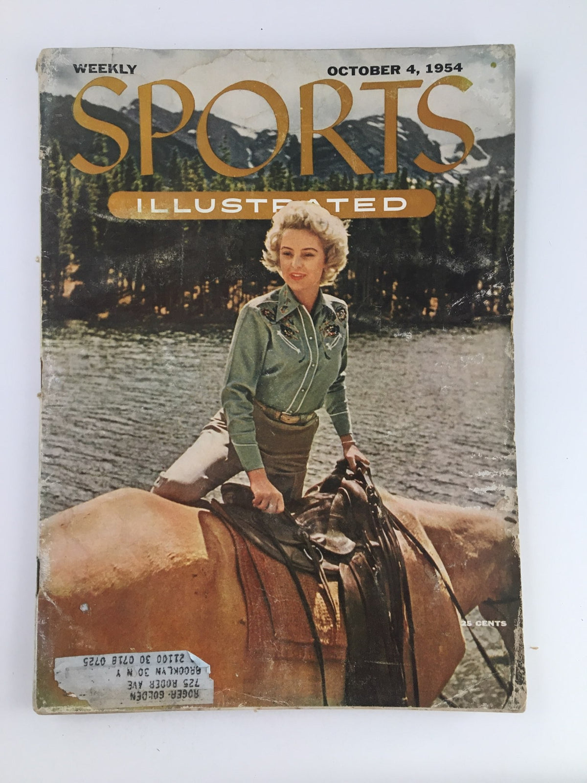 Vintage Sports Illustrated Magazine from October 4, 1954 featuring a cover image of Joyce Sellers, a prominent cowgirl, perched on a horse in a scenic outdoor setting, showcasing the cultural significance of women in sports.