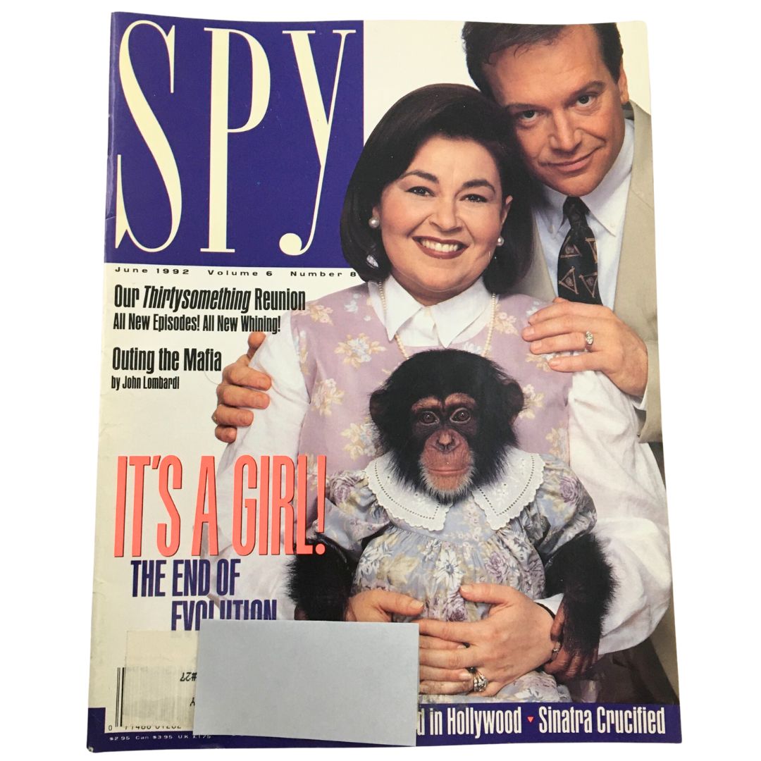 Cover of Spy Magazine, June 1992, Vol 6 #8 featuring celebrity couple Tom Arnold and Roseanne Barr, along with a chimpanzee wearing a dress. The magazine headline reads 'It's a Girl! The End of Evolution'.