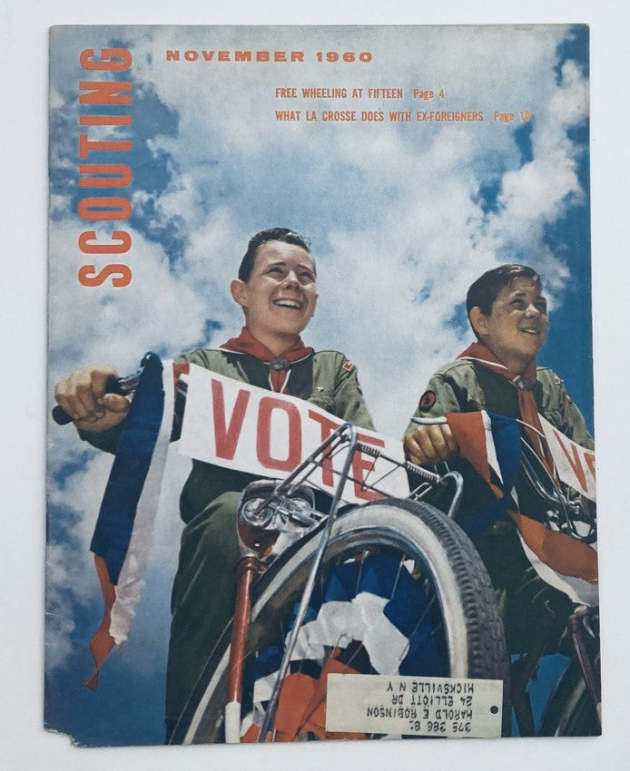 Cover of VTG Scouting Magazine November 1960 featuring two young scouts on a bicycle holding 'Vote' signs under a blue sky, illustrating the theme 'Free Wheeling at Fifteen'.