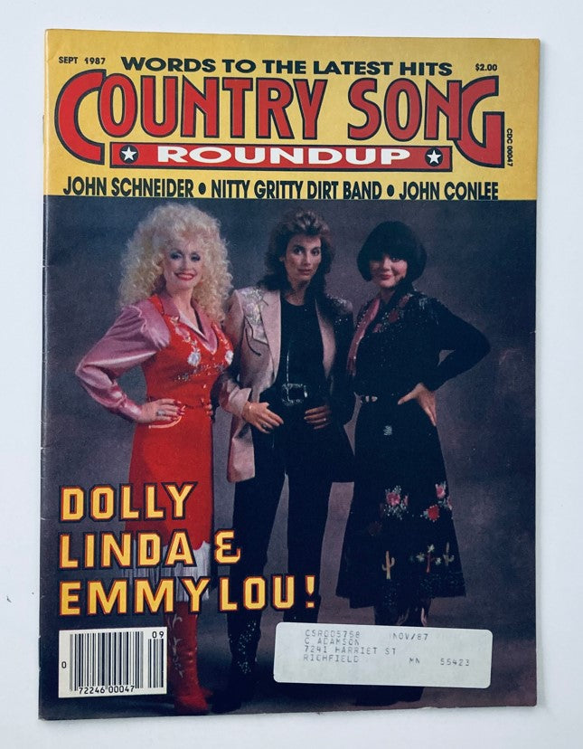 Cover of the VTG Country Song Roundup Magazine from September 1987 featuring Dolly Parton, Linda Ronstadt, and Emmylou Harris, highlighting their status as iconic country music stars.
