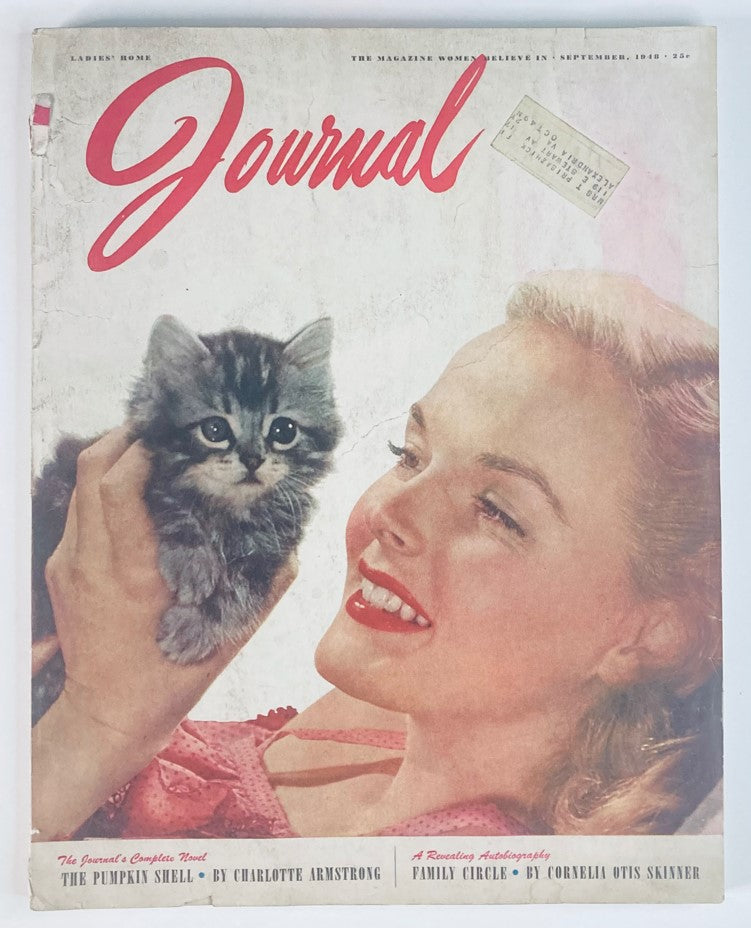 Cover of Ladies' Home Journal Magazine September 1948, featuring a smiling woman with red lipstick holding a fluffy kitten, with the title 'Journal' prominently displayed.