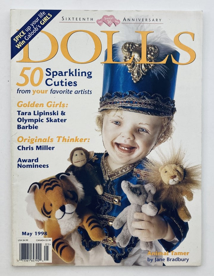 Cover of Dolls Magazine May 1998 Vol 17 No. 4 featuring the article 'Animal Tamer' by Jane Bradbury, showcasing a child dressed in a blue costume holding stuffed animals including a tiger, monkey, and lion.