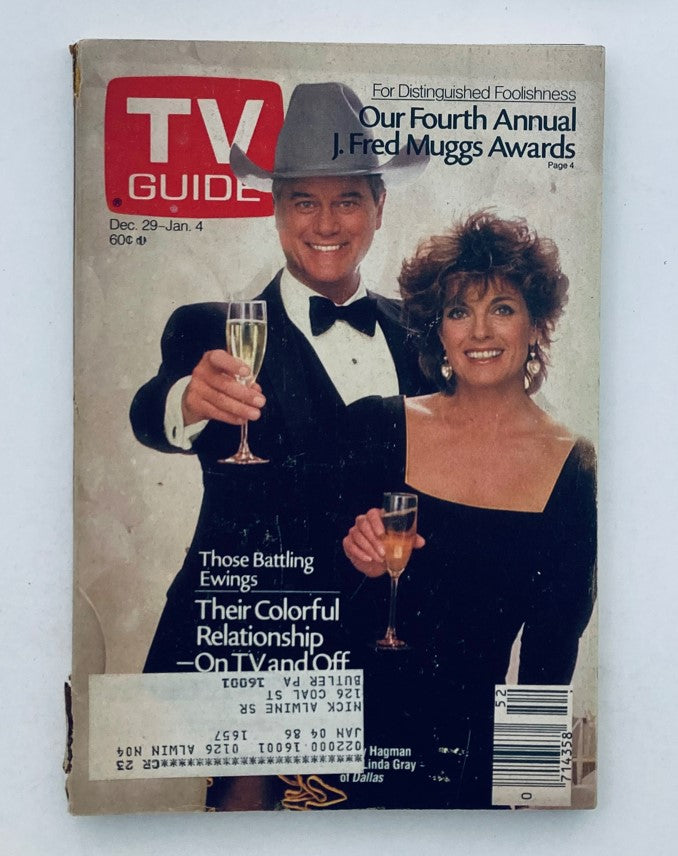 TV Guide Magazine cover from December 29, 1984 featuring Larry Hagman and Linda Gray celebrating with drinks, showcasing content related to their roles on Dallas.