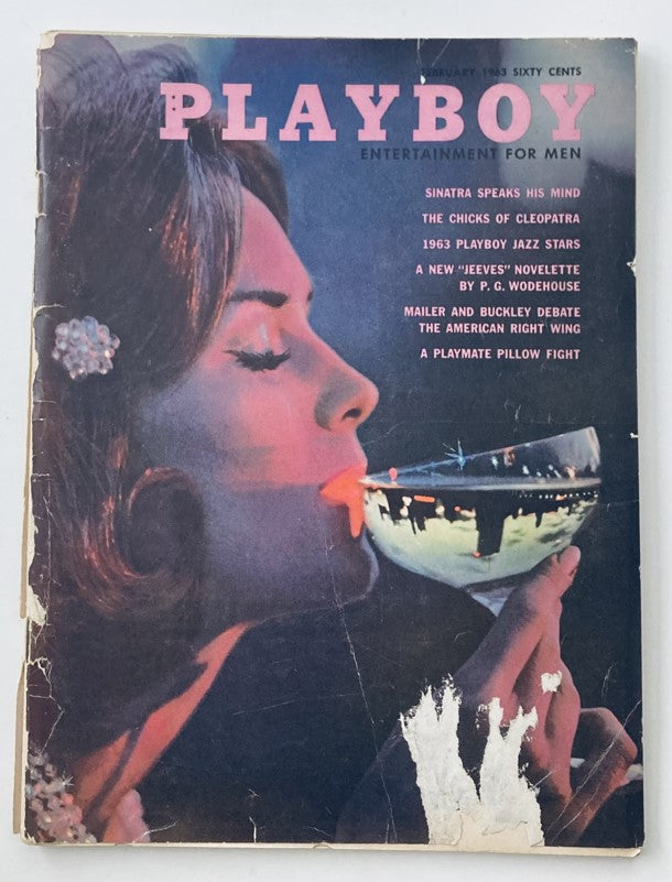 VTG Playboy Magazine February 1963 Cover featuring a glamorous woman holding a glass, showcasing vintage fashion and culture.