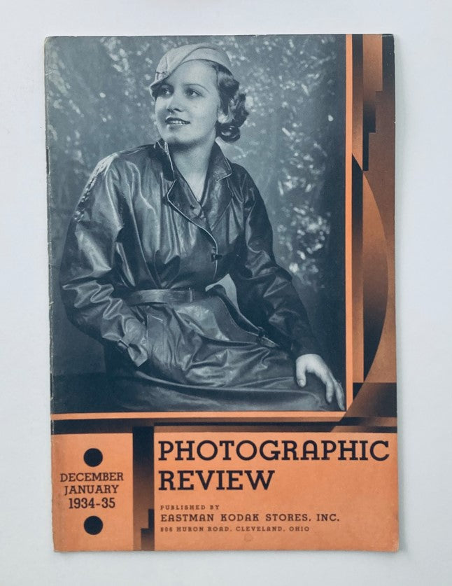 Cover of the VTG Photographic Review Magazine from December 1934 titled 'The Infant Grows Up,' featuring a woman in a stylish black leather coat and hat.