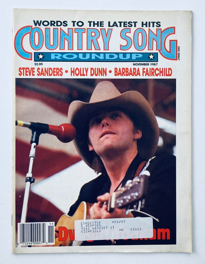Cover of the VTG Country Song Roundup Magazine from November 1987 featuring artists Steve Sanders, Holly Dunn, and Barbara Fairchild, highlighting the iconic Dwight Yoakam with a guitar.