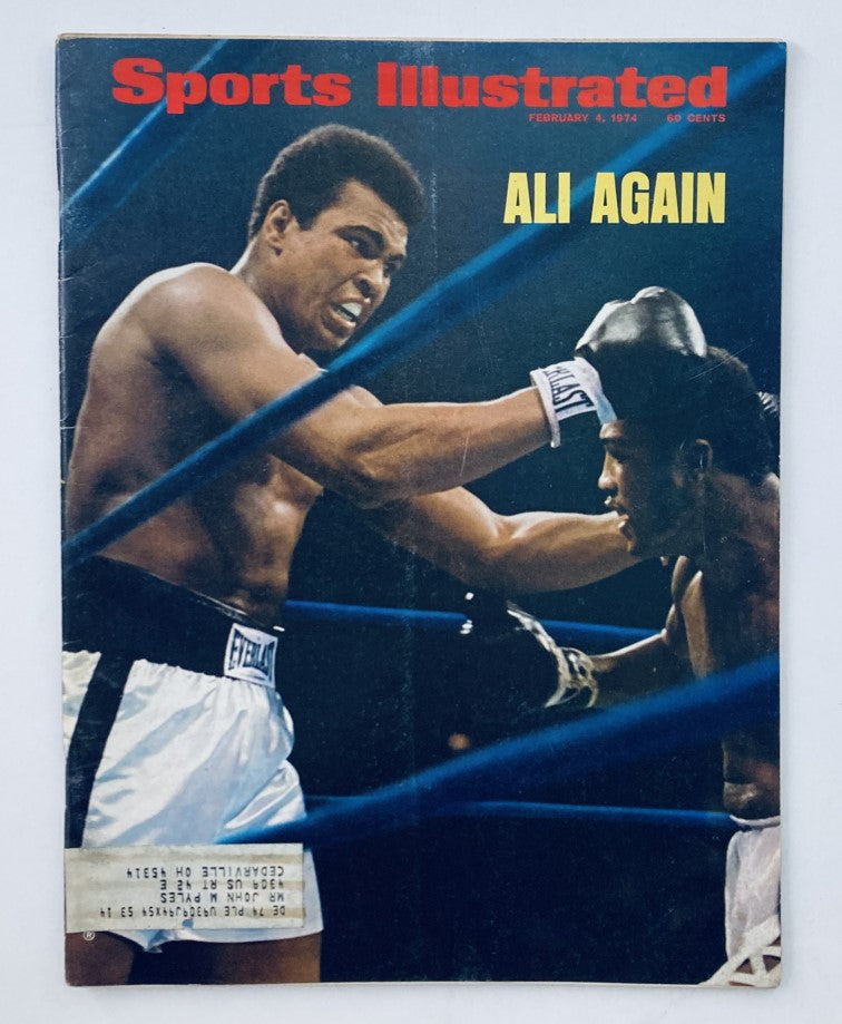 Sports Illustrated Magazine February 4 1974 cover featuring Muhammad Ali delivering a punch during his boxing match against Joe Frazier II, highlighting a pivotal moment in sports history.