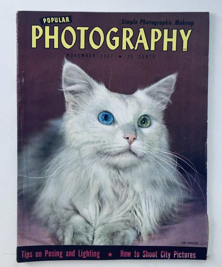 Cover of VTG Popular Photography Magazine November 1947, Volume 21, Number 5, featuring a striking photograph of a white cat with two different colored eyes, highlighting themes of simple photographic makeup, tips on posing and lighting, and shooting city pictures.