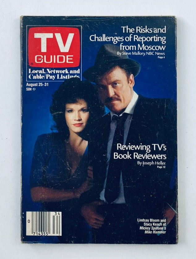 TV Guide Magazine August 25 1984 featuring Stacy Keach and Lindsay Bloom on the cover. The cover showcases the magazine's prominent title and headline discussing the risks of reporting from Moscow, along with a feature on reviewing TV's book reviewers.