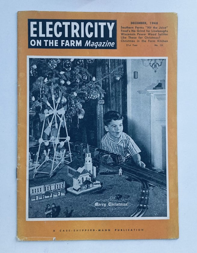 Cover of VTG Electricity on the Farm Magazine December 1948 featuring a boy with a Christmas tree and toy train set.
