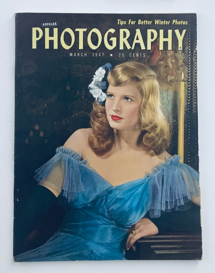 Cover of the VTG Popular Photography Magazine, March 1947 edition featuring a woman in a blue dress, highlighting tips for better winter photos.