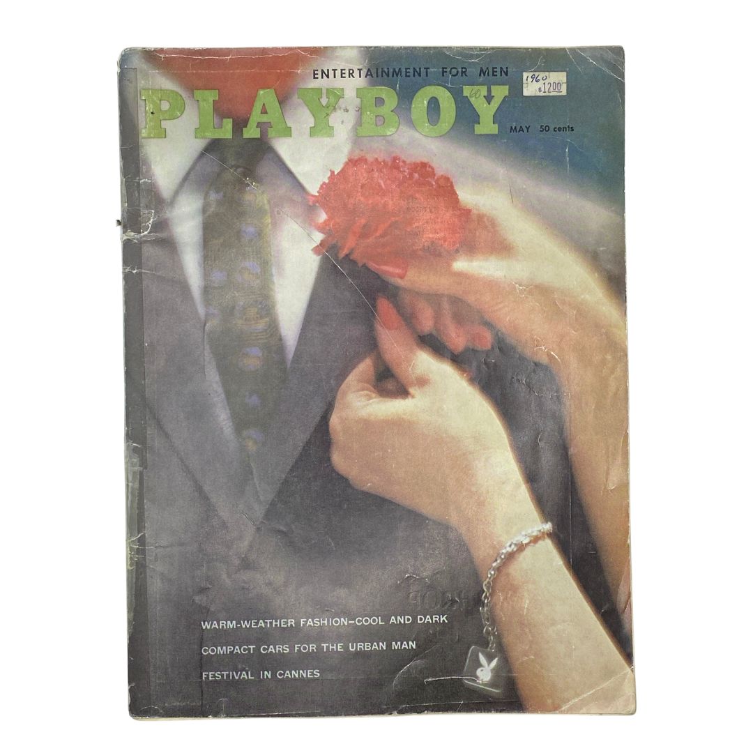 Vintage Playboy Magazine May 1960 featuring a cover image with a man in a suit holding a flower and a woman, showcasing the magazine's nostalgic appeal.