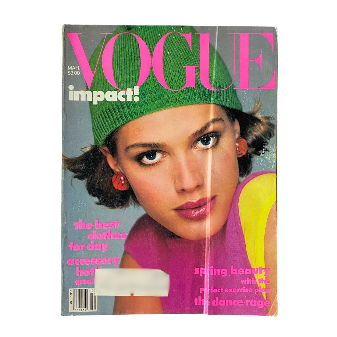 Cover of VTG Vogue Magazine March 1984 featuring Beth Rupert, styled with a green hat and vibrant makeup.