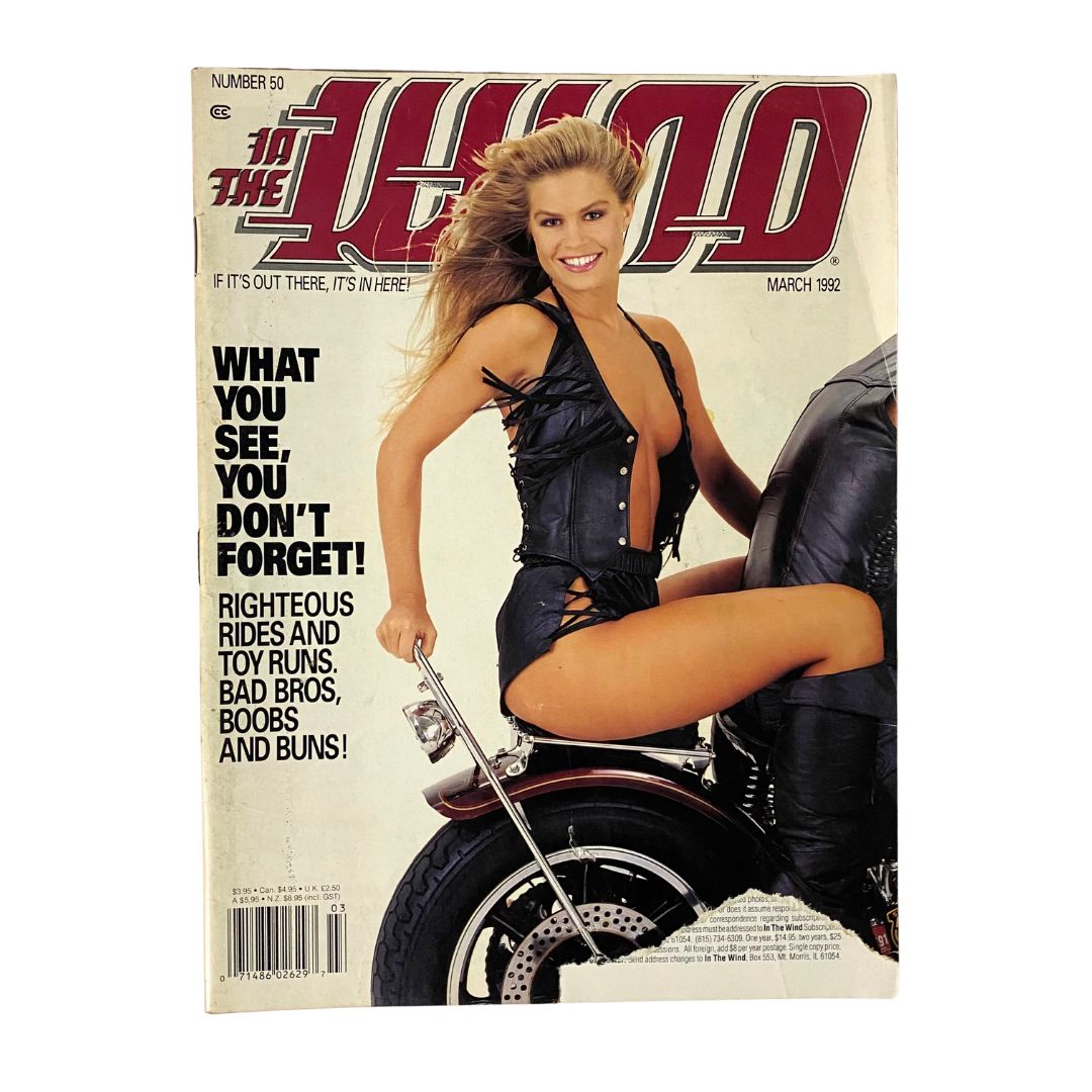 Cover of 'In The Wind Magazine March 1992' featuring a woman in a revealing outfit sitting on a motorcycle, capturing the bold and adventurous spirit of the early '90s motorcycle culture.