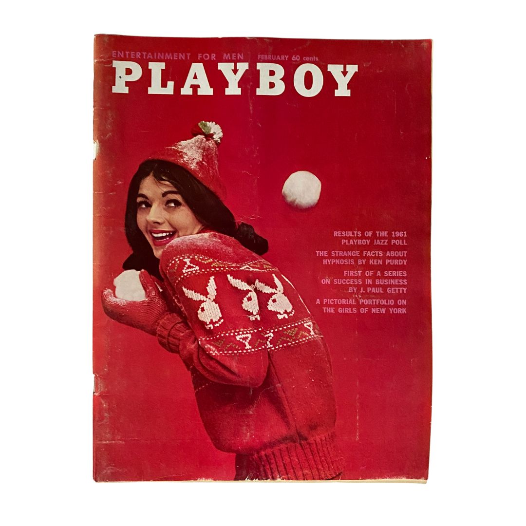 VTG Playboy Magazine February 1961 featuring a smiling woman in a festive red sweater and hat, holding snowballs on the cover, showcasing iconic vintage design.