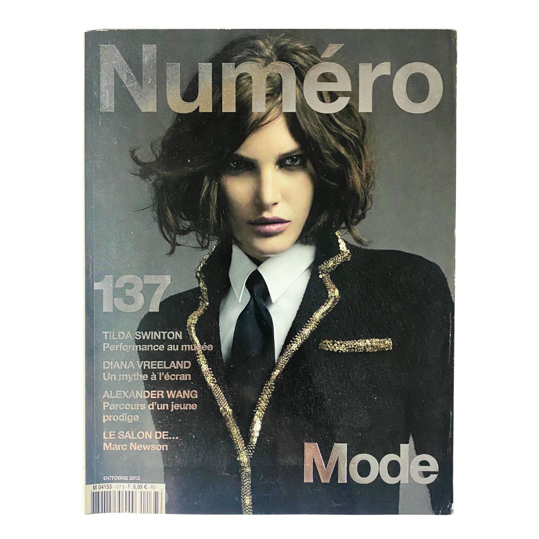 Cover of Numéro Magazine October 2012 No. 137 featuring Tilda Swinton in a stylish black and gold jacket, showcasing the artistic design and high-fashion theme.