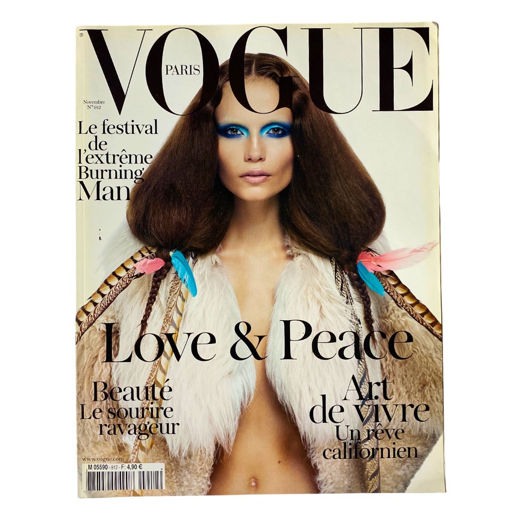 Vogue Paris November 2010 magazine cover featuring Natasha Poly with bold blue eye makeup and a stylish fur coat, titled 'Love & Peace'.