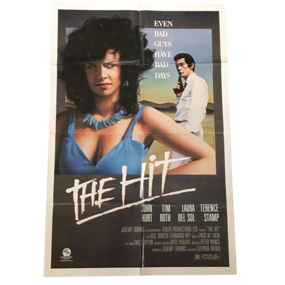 1984 The Hit 41" x 27" Original Movie Poster featuring John Hurt and Terence Stamp, showcasing a dramatic design with a female character in a blue top and a male character in a suit, emphasizing the tagline 'Even Bad Guys Have Bad Days'.