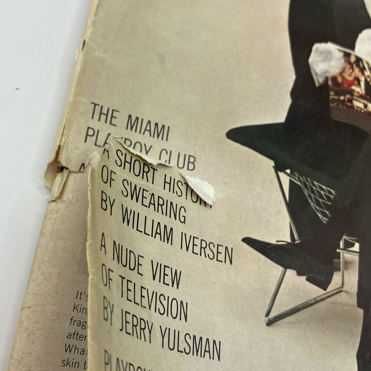 Close-up of the cover damage on VTG Playboy Magazine September 1961, displaying wear and tear typical of vintage publications.