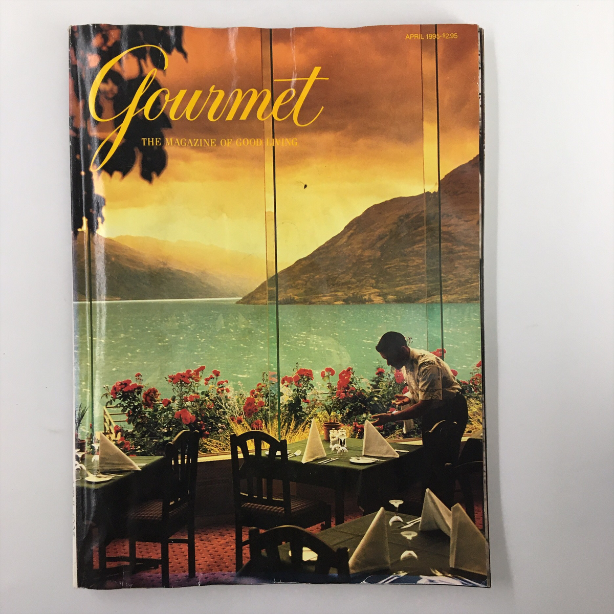 Cover of Gourmet Magazine April 1995 featuring a sunset over Lake Wakatipu in Queenstown, with a dining setup overlooking the lake.