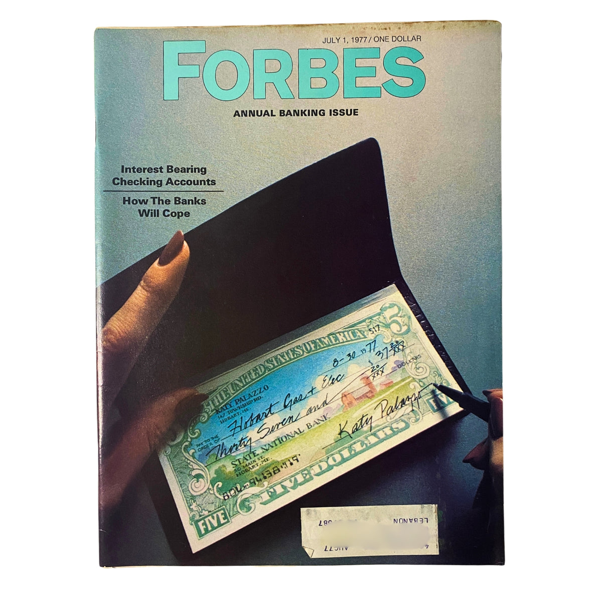 Cover of Forbes Magazine dated July 1, 1977, featuring a cover story on Interest Bearing Checking Accounts and an image of a hand holding a check.